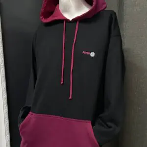 Polerón moderno negro y burdeos con bordado Jano, ideal para un look casual y cómodo.